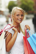 Happy young woman with shopping bags