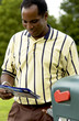 Foto: African American man getting mail from mailbox African American man getting mail from mailbox