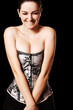 Smiling woman with cleavage in a corset