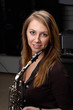 young female play in study on  saxophone