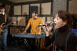 vocalist is singing. musicians in out of focus