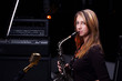 young female play in study on  saxophone