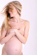 undressed pregnant female holding her breasts undressed pregnant female holding her breasts