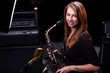 young female play in study on  saxophone