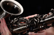 hand on buttons of saxophone