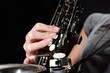 hand on buttons of saxophone