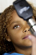 African American girl getting eye exam