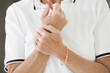 Senior woman grasping hands