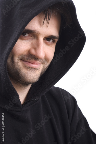 Photo: Man smiling in black sweatshirt with hood on white background Man smiling in black sweatshirt with hood on white background