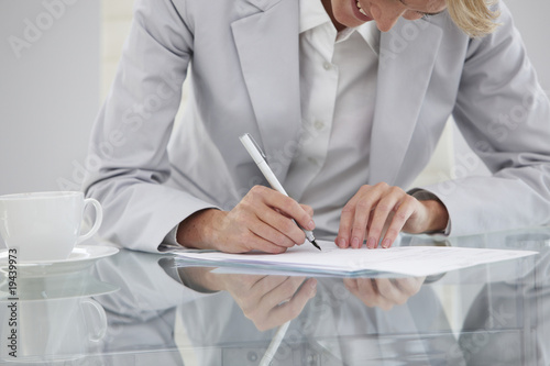 Photo: Girl signing a contract Girl signing a contract