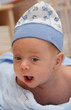 A cute 2 months old baby boy in a hat