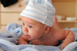 A cute 2 months old baby boy in a hat