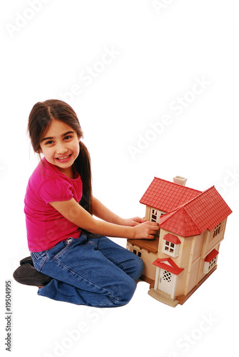 Photo: Young girl playing with house Young girl playing with house
