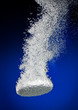 Effervescent tablet in water with bubbles