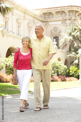 Photo: Senior Couple Walking Through City Street Senior Couple Walking Through City Street