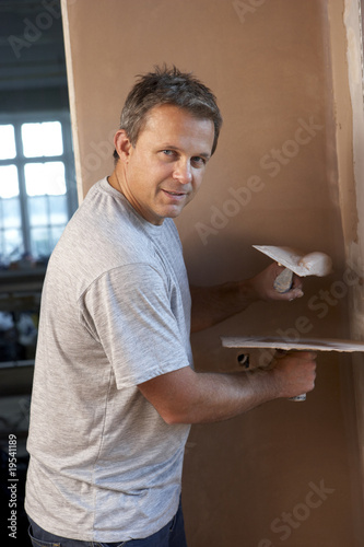 Photo: Plasterer Working On Interior Wall Plasterer Working On Interior Wall