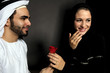 An Emirati Man Gives A Rose To His Wife