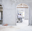 Couple looking at blueprints in house under construction