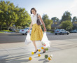 Woman dropping groceries on sidewalk