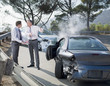 Two businessmen arguing about damaged cars