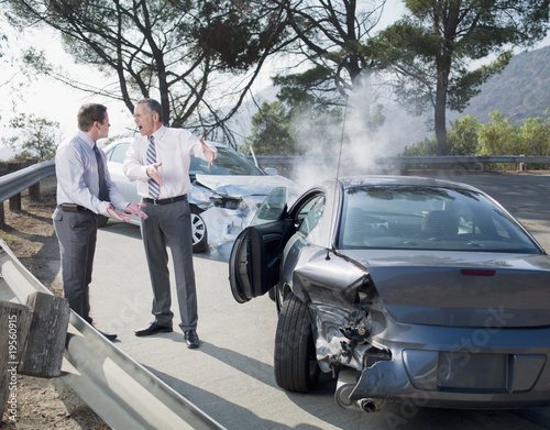 Photo: Two businessmen arguing about damaged cars Two businessmen arguing about damaged cars