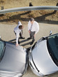 Two businessmen arguing about damaged cars