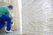 Delivery man taping cardboard boxes in warehouse