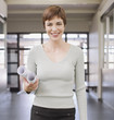 Businesswoman holding blueprints in office