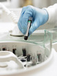 Scientist inserting test tube into centrifuge