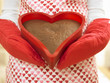 Close up of woman holding heart-shaped cake