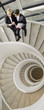 Business people talking on circular staircase