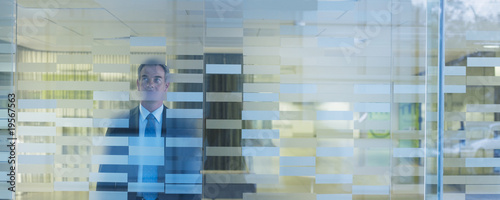 Photo: Businessman standing in modern office Businessman standing in modern office