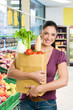 Young woman with grocery bag in market