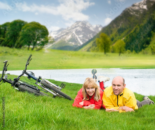 two cyclists on river bank