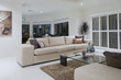 Luxurious living room with dining table in the background