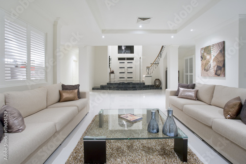 Photo: Luxurious living room with grand entrance in the background Luxurious living room with grand entrance in the background