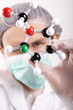 Scientist looking over Atoms