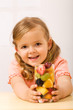 Happy little girl with fruity refreshment