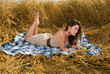 Beautiful slavonic girl on picnic in wheat field with apple