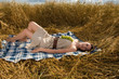 Beautiful slavonic girl on picnic in wheat field with grapes