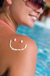 A smile made with suncream at the shoulder (shallow dof)