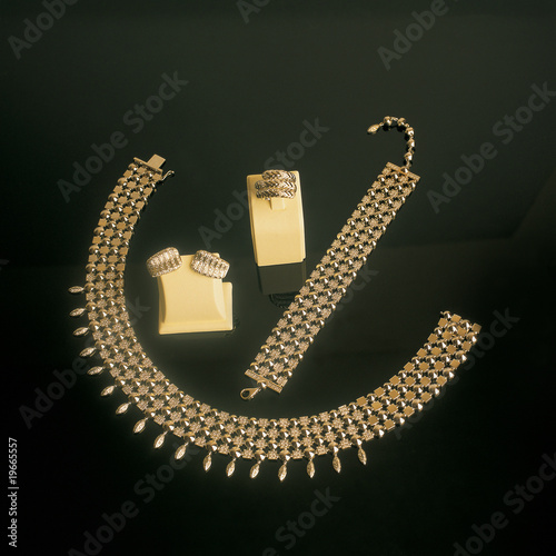 Photo: close up shot of gold jewelry on black close up shot of gold jewelry on black