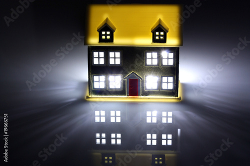 Illustration: One house lit at night One house lit at night