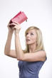 Very surprised adult girl with empty purse