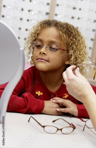 Photo: African American girl trying on glasses African American girl trying on glasses