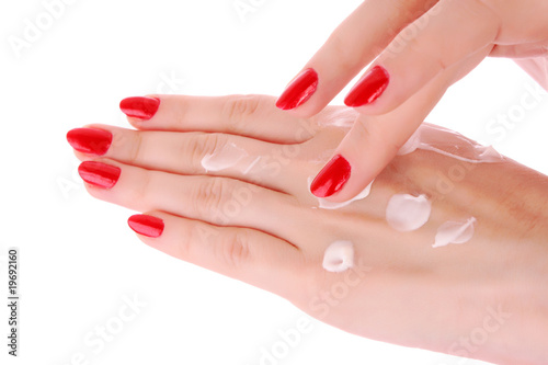 Photo: Two woman hands with body cream. Isolated on white. Two woman hands with body cream. Isolated on white.
