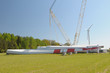 Windmill power generator components on the green field. Windmill power generator components on the green field.