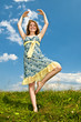 Young girl dancing in meadow