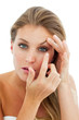 Concentrated woman putting a contact lens Concentrated woman putting a contact lens