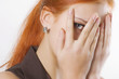 Woman peeking through fingers